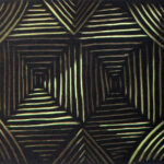 A black and gold tile with lines on it.