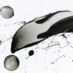 A black and white painting with splashes of ink.